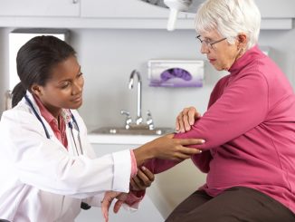 Female Doctor Examining Elderly Female Patient With Elbow Pain