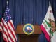 Press conference of governor of the state of California concept. Seal of the governor of the State of California on the tribune with flag of USA and California state.